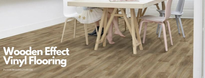 Girl sitting at kitchen table with wooden effect vinyl flooring.