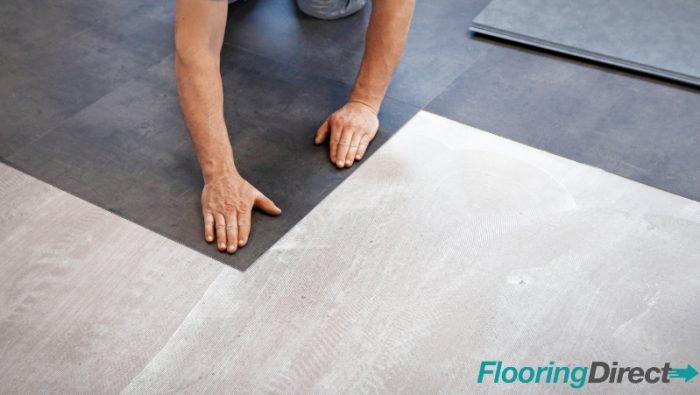 Someone laying a vinyl floor